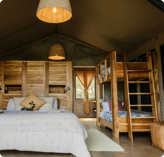 A warm timber lodge guest room with woven lights